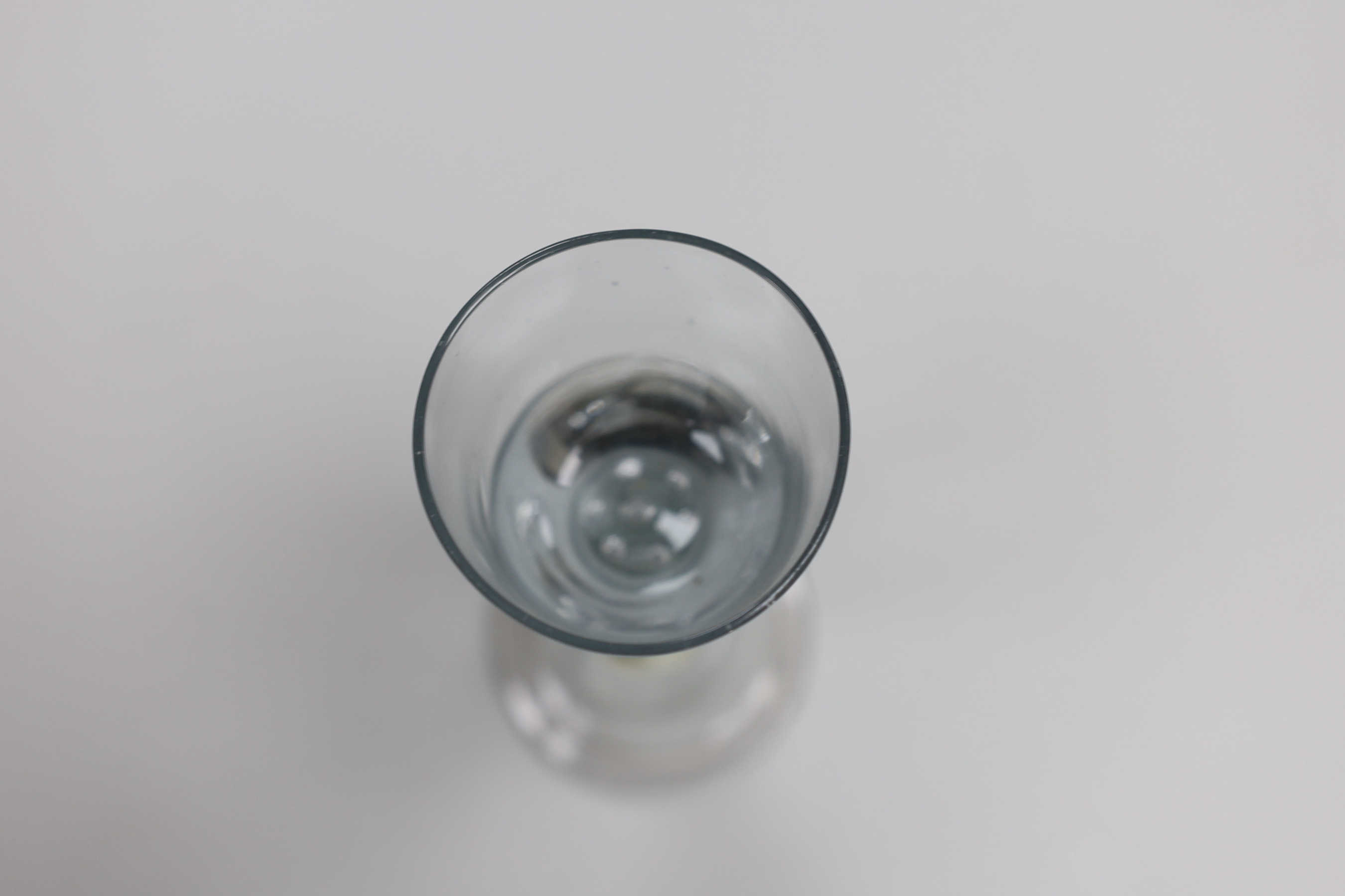 An unusual George II wine glass, bowl with air-tears, angular knop and domed foot, 13.5cm tall